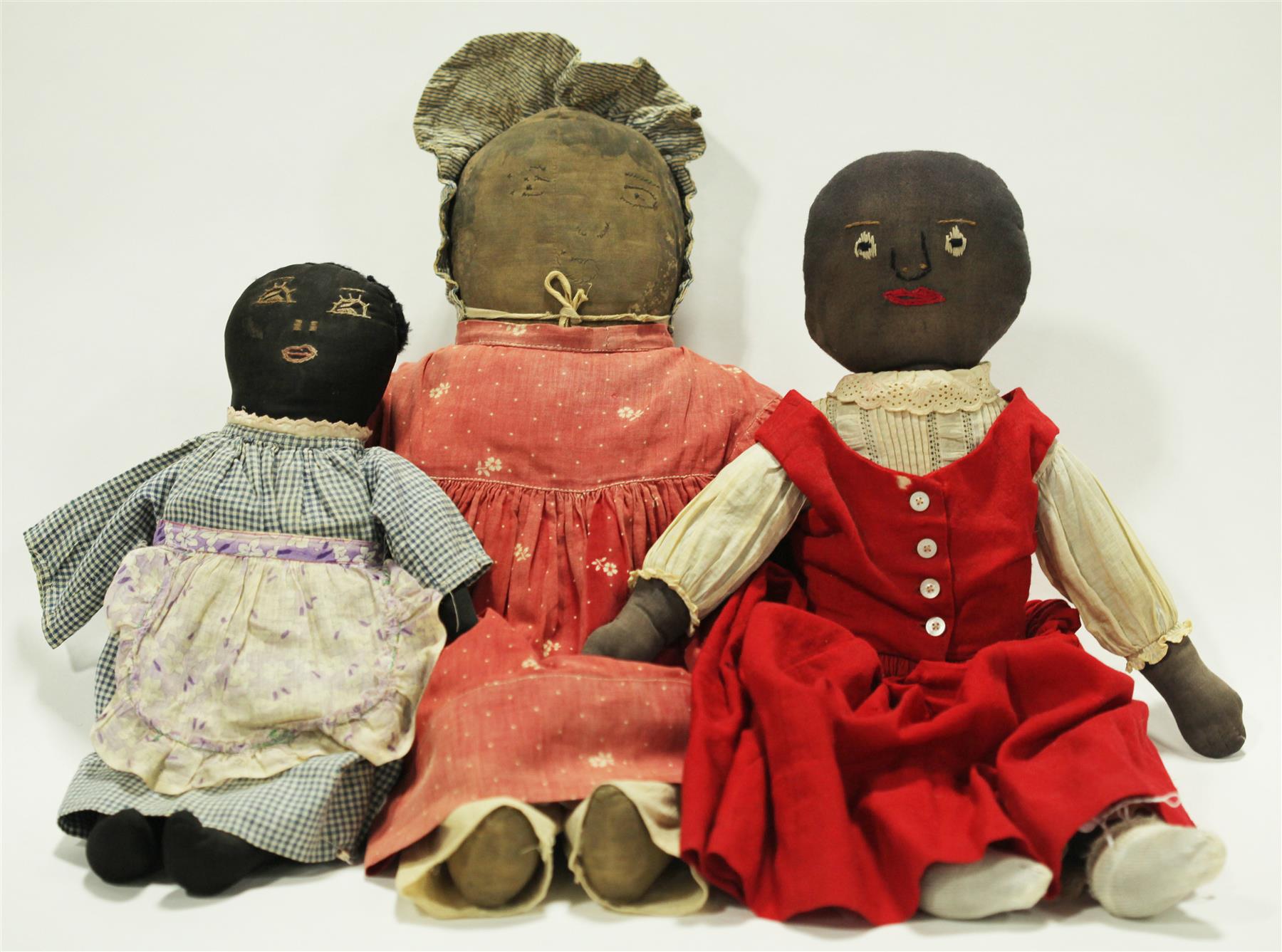 Appraisal: THREE EARLY BLACK CLOTH DOLLS Late th-early th century All