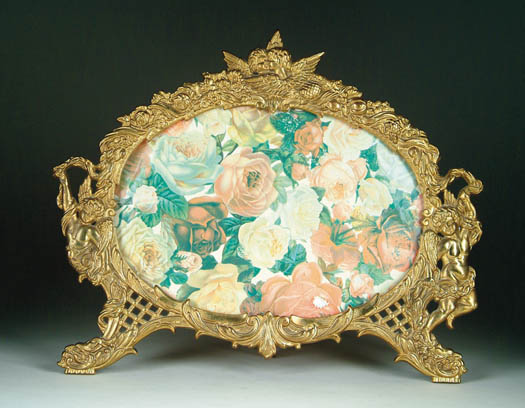 Appraisal: BRASS OVAL FIGURAL PICTURE FRAME Tabletop frame has easel back