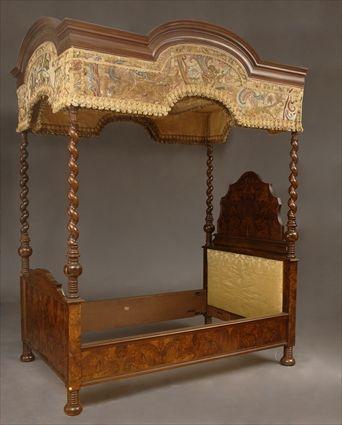 Appraisal: BAROQUE-STYLE FIGURED WALNUT FOUR-POSTER TESTER BEDSTEAD The breakarch crewelwork-hung canopy