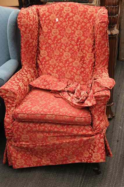 Appraisal: AN OLD WING BACK CHAIR on shaped feet wide