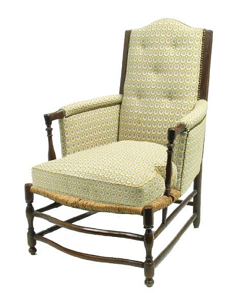 Appraisal: A French Provincial pine and rush upholstered armchair height in