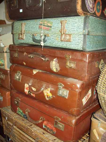 Appraisal: A COLLECTION OF FIVE 'S SUITCASES WITH THREE LARGE CANE