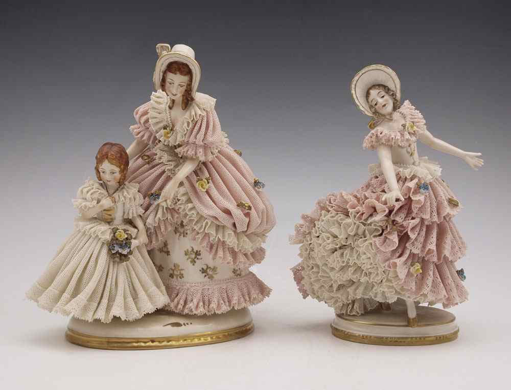 Appraisal: TWO FURSTENBERG LACY FIGURINES Figural group of woman with a