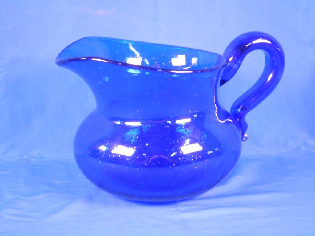 Appraisal: A thC Bristol blue glass jug with a scroll handle