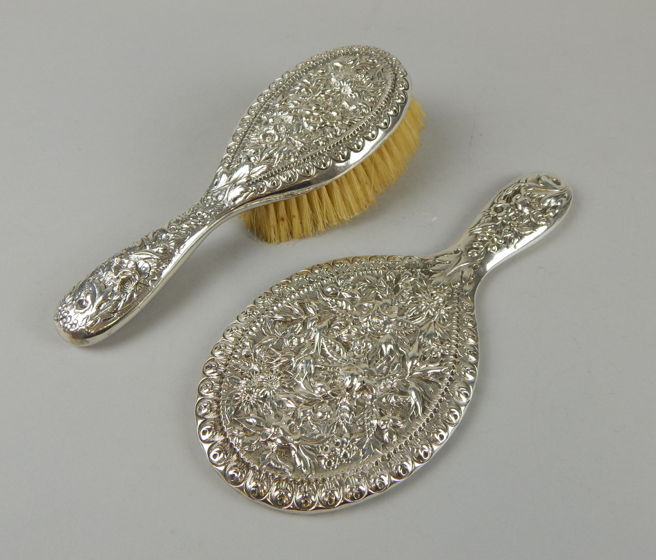 Appraisal: A sterling silver hand mirror and matching hairbrush each heavily