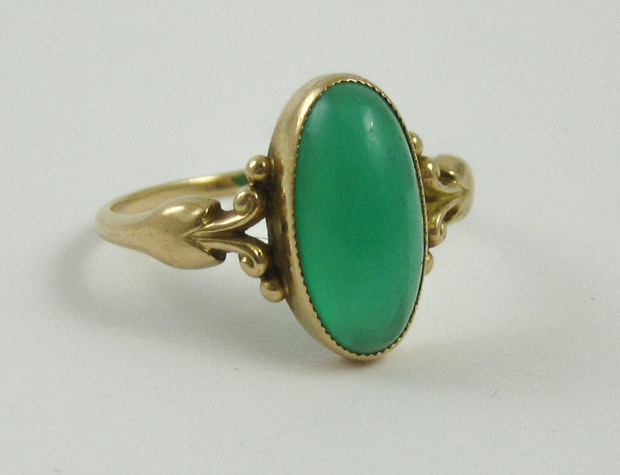 Appraisal: GREEN CABOCHON AND EIGHTEEN KARAT GOLD RING set with an