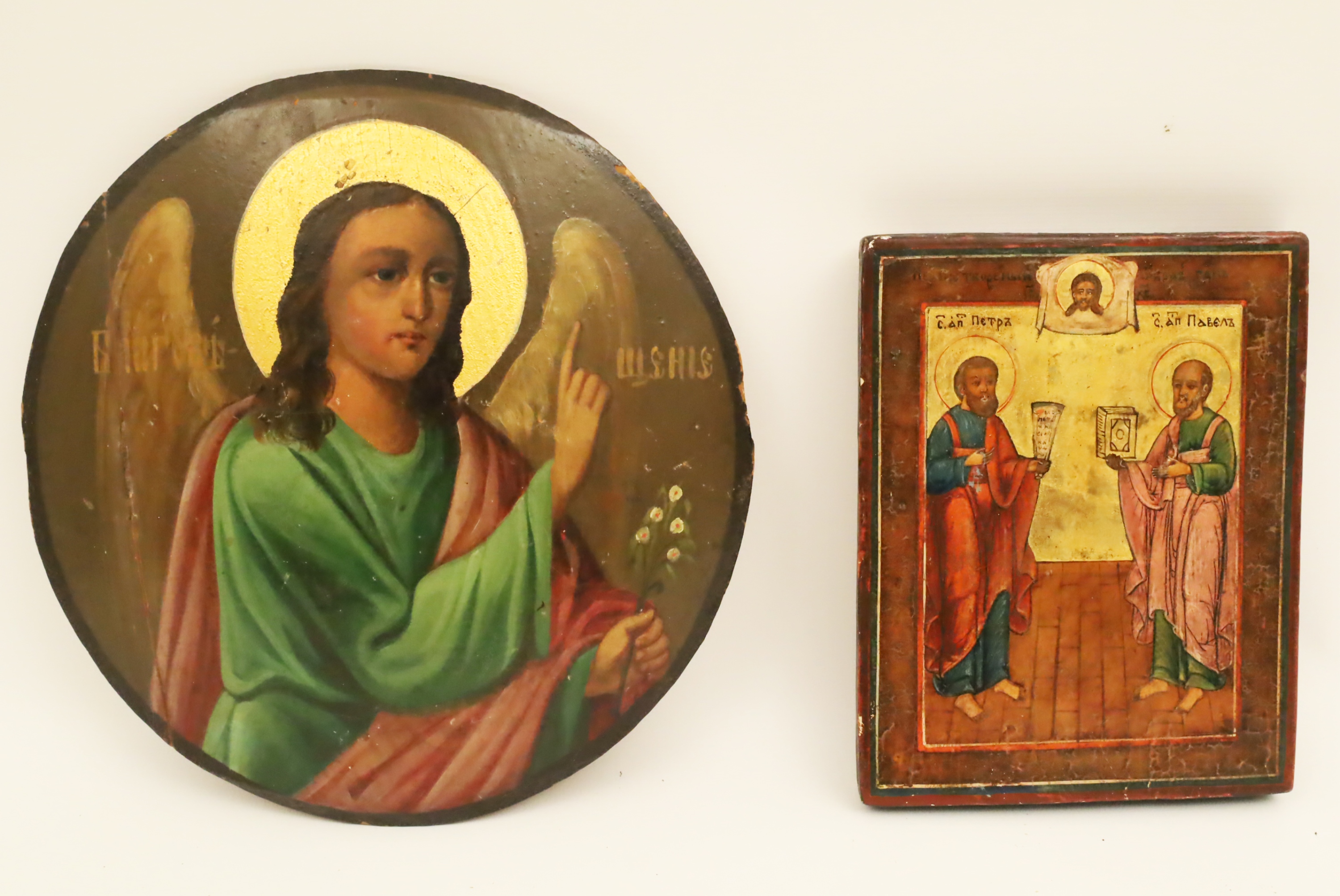 Appraisal: TWO RUSSIAN ICONS Including an unusual disc form wooden icon