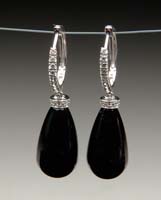 Appraisal: PAIR OF DIAMOND AND BLACK ONYX EARRINGS Teardrop shaped onyx