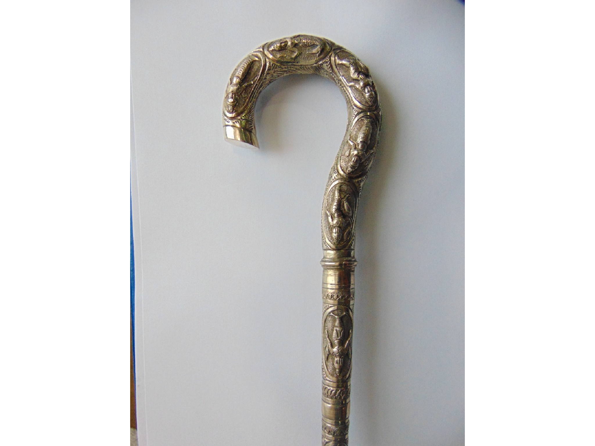 Appraisal: A slender bamboo walking cane terminating in an elongated Eastern