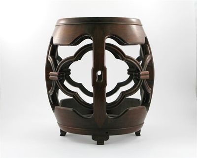 Appraisal: A Chinese hardwood barrel-shaped garden seat the sides with fretwork