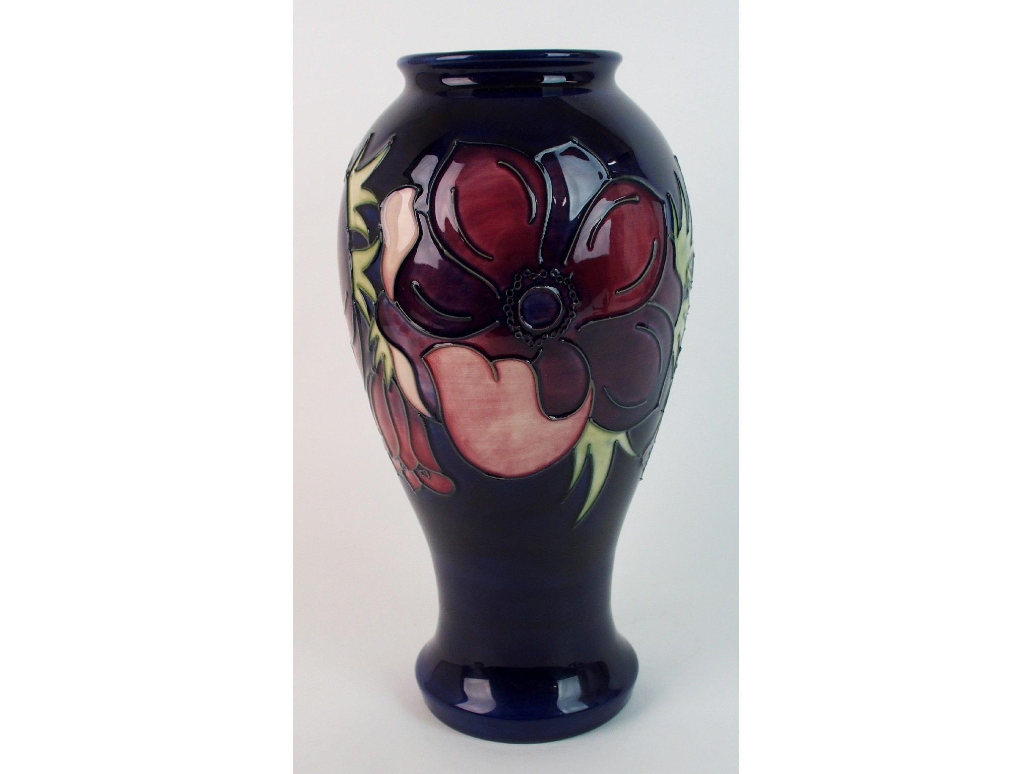 Appraisal: A Moorcroft pottery anemone vasethe tubelined vase decorated with stylised