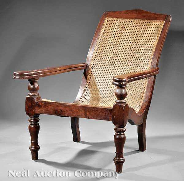 Appraisal: A Colonial-Style Carved Hardwood Planter's Chair arched crest rail elongated