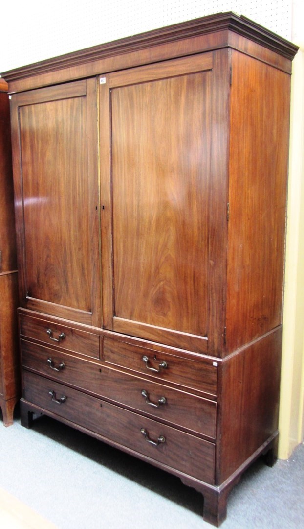 Appraisal: A George III mahogany linen press the pair of panel