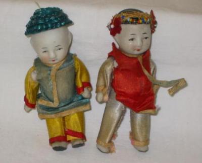 Appraisal: A pair of all bisque Oriental dolls house dolls with