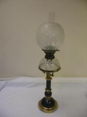 Appraisal: A VICTORIAN OIL LAMP the ebonised wood and brass column