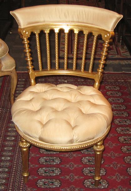 Appraisal: Continental giltwood upholstered sidechairWith a shaped backrest above turned backsplats