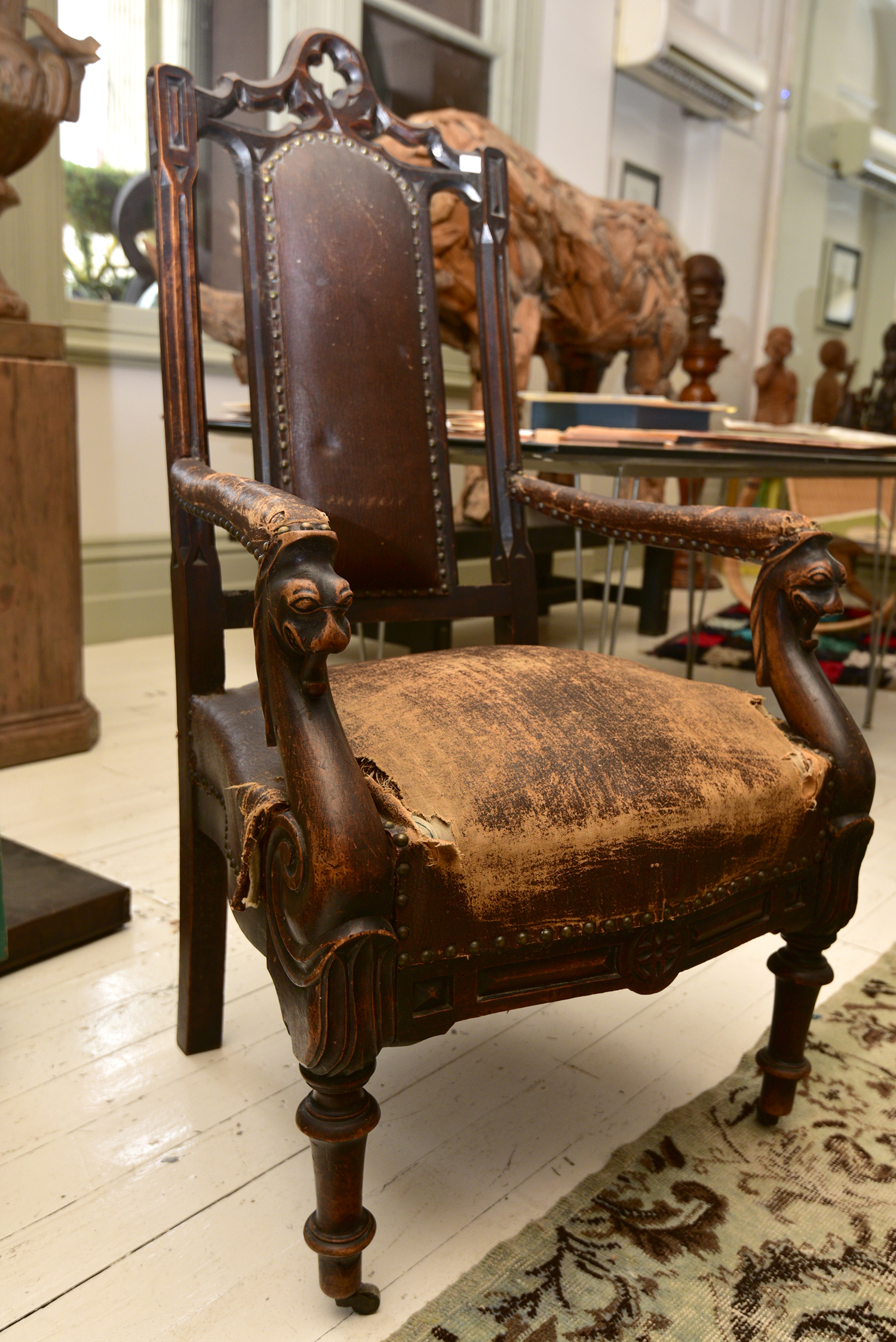 Appraisal: A GOTHIC REVIVAL ARM CHAIR IN DISTRESSED UPHOLSTERY h x