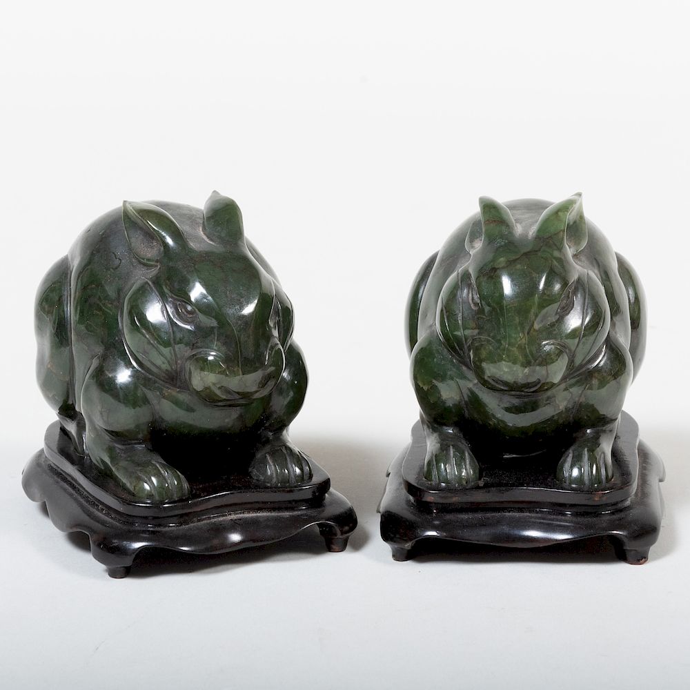 Appraisal: Two Chinese Hardstone Rabbits Modern Each raised on a stand