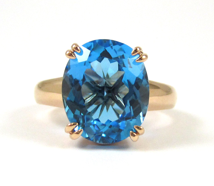 Appraisal: BLUE TOPAZ AND FOURTEEN KARAT ROSE GOLD RING set with