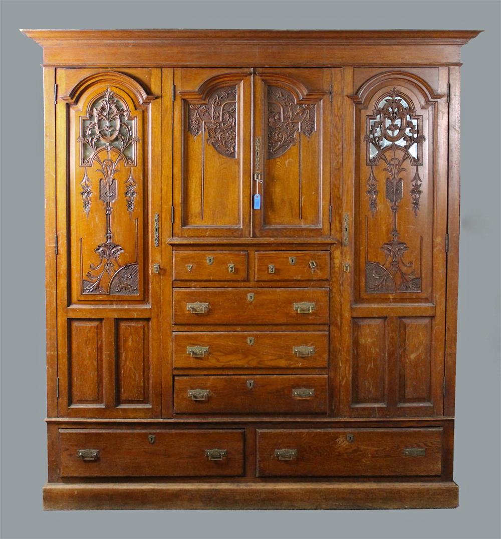 Appraisal: RENAISSANCE REVIVAL OAK ARMOIRE having a carved shaped pediment over