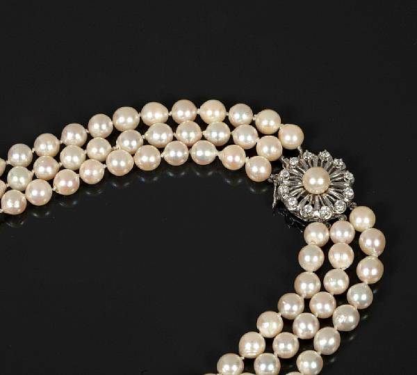 Appraisal: A triple strand of cultured pearls with a diamond and