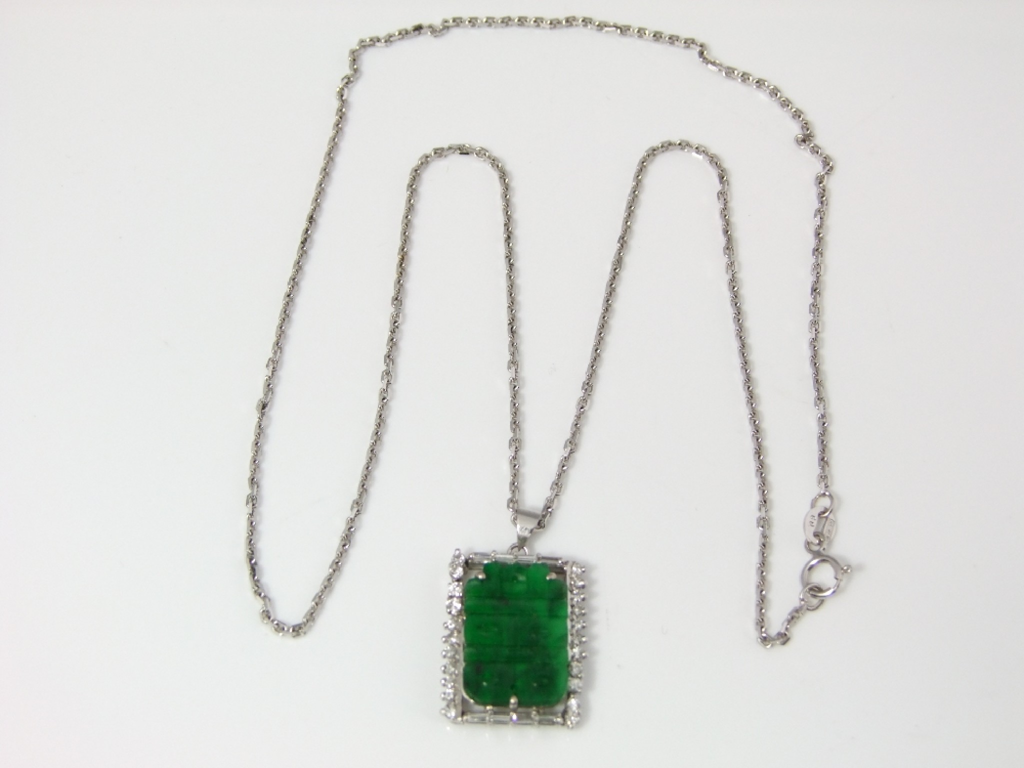 Appraisal: An ct white gold pendant supporting a carved jade panel