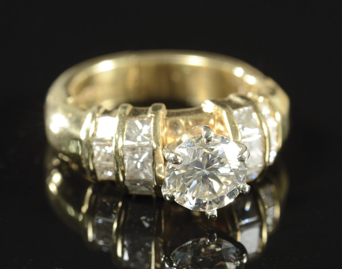 Appraisal: DIAMOND AND FOURTEEN KARAT GOLD RING with six princess-cut diamonds