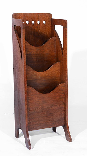 Appraisal: An early th Century Glasgow School oak magazine rackwith pierced