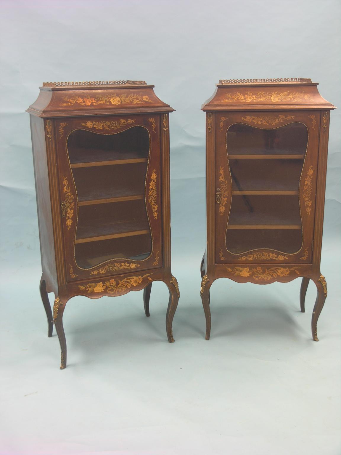 Appraisal: A pair of Edwardian mahogany and marquetry display cabinets with