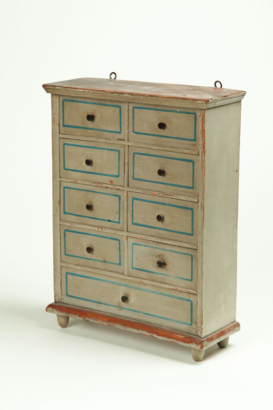 Appraisal: DECORATED SPICE CHEST American th century pine Eight small drawers