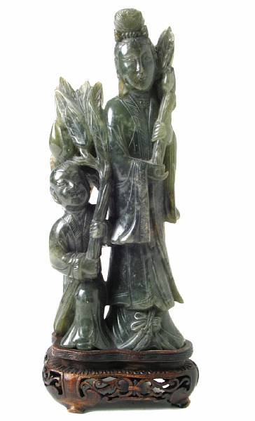 Appraisal: A Chinese carved hardstone Guanyin with child attendant height in