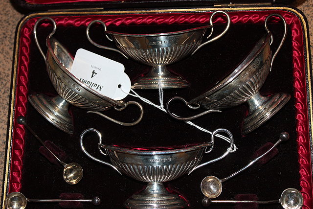 Appraisal: A CASED SET OF FOUR VICTORIAN NAVETTE SHAPED SILVER SALTS