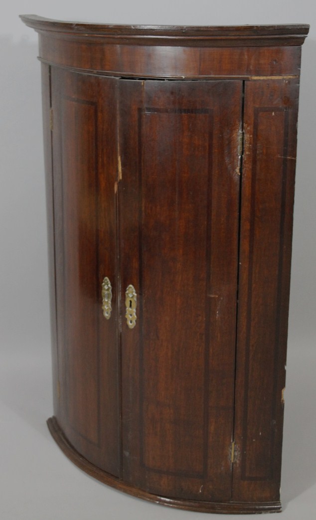 Appraisal: An thC oak barrel corner cupboard with double doors hinging