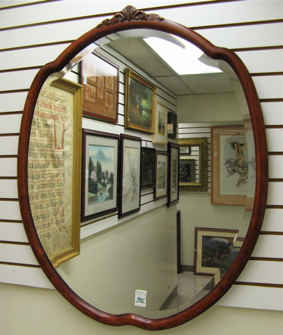 Appraisal: AN AMERICAN SHIELD-SHAPED WALL MIRROR in mahogany frame with crest