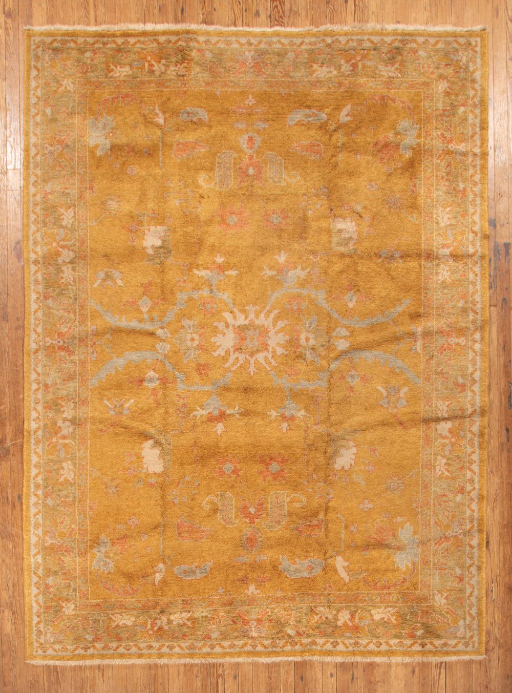 Appraisal: Large Oushak Carpet mustard ground stylized foliate design in red