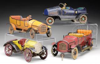 Appraisal: GROUP OF FOUR CLOCKWORK TIN AUTOMOBILE TOYS GROUP OF FOUR