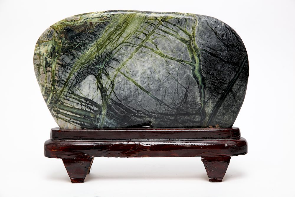 Appraisal: Chinese Scholar's Rock on Polished Wood Stand Chinese polished green