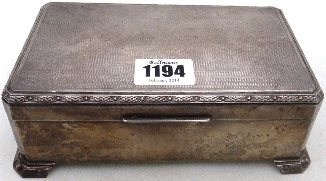 Appraisal: A silver rectangular table cigarette box the cover with engine