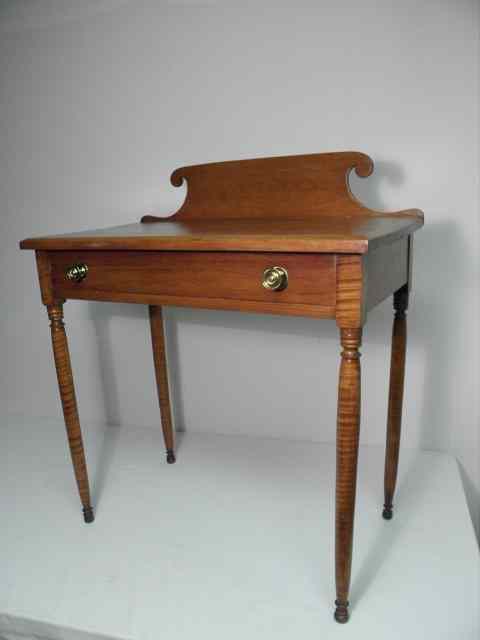 Appraisal: A th century Sheraton style curly maple dressing table with