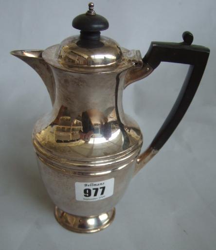 Appraisal: A silver hot water jug of baluster from with black