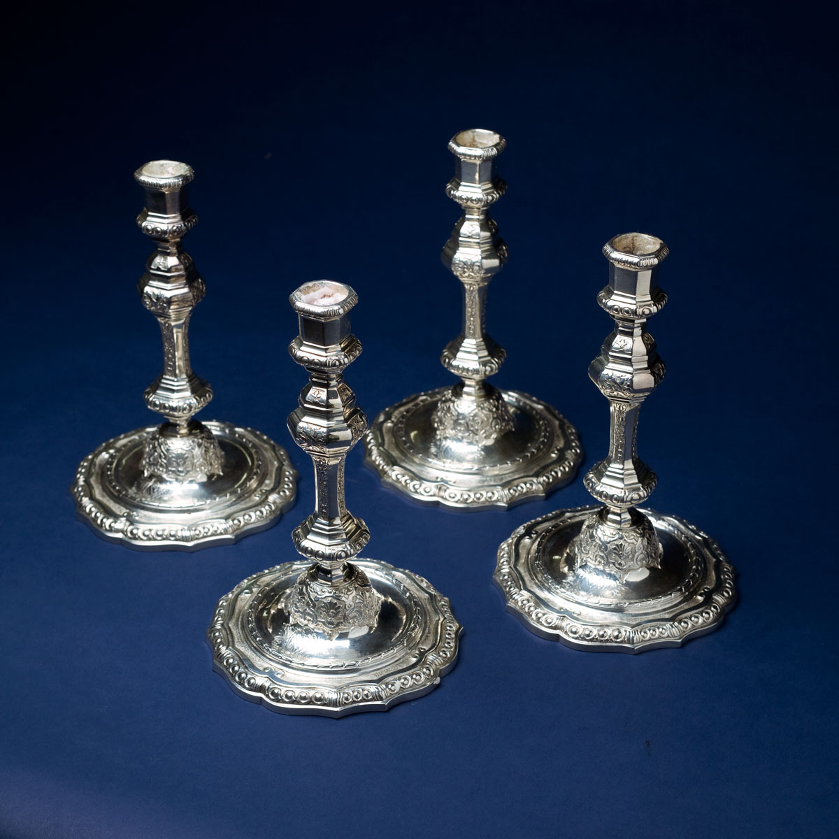 Appraisal: SET OF FOUR GEORGE II SILVER CAST ARMORIAL CANDLESTICKS LONDON