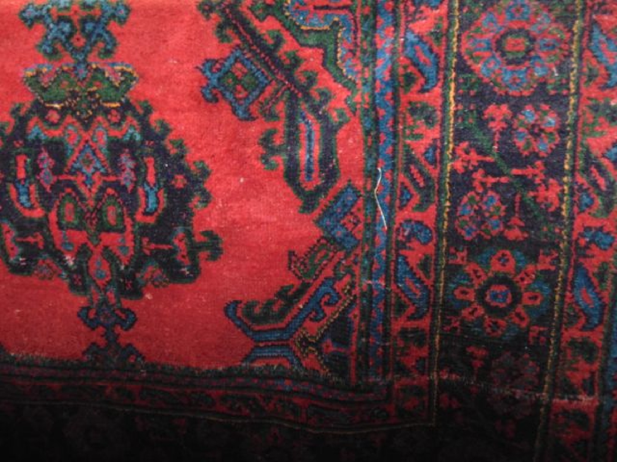 Appraisal: A large Turkey wool carpet with typical red ground overlaid