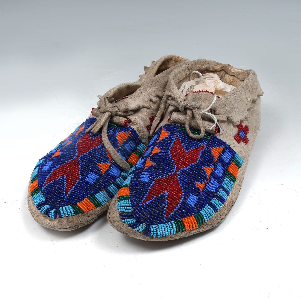 Appraisal: SHOSHONE BEADED MOCCASINS Traditional pair of lazy stitch beaded light