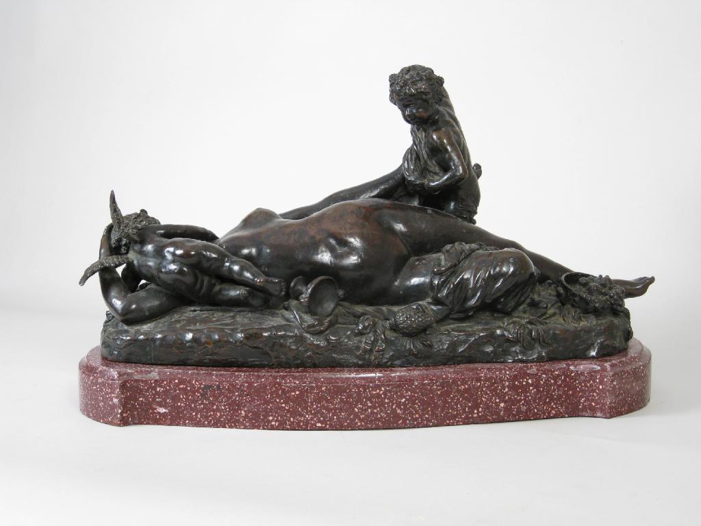 Appraisal: A bronze Figure Group of reclining female nude with faun