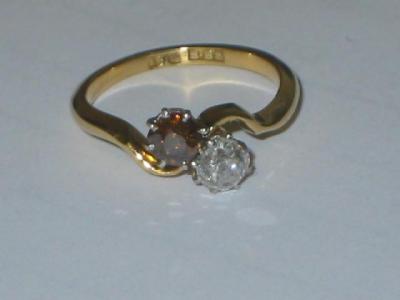 Appraisal: A TWO STONE DIAMOND RING comprising a cognac diamond and