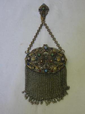 Appraisal: A GILDED METAL PURSE the pierced oval top with butterfly