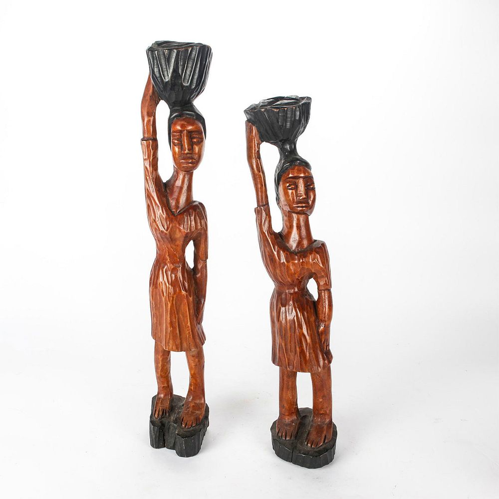 Appraisal: PAIR HAND CARVED AFRICAN FEMALE FIGURAL SCULPTURES Women carrying baskets