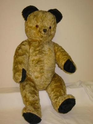 Appraisal: An English teddy bear straw filled covered in gold plush