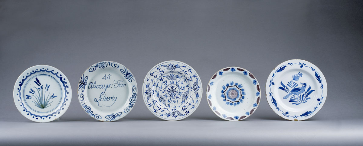 Appraisal: TWO ENGLISH DELFT POLYCHROME PLATES The first painted in shades