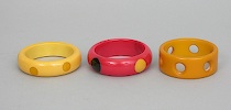 Appraisal: Three Bakelite Bangels One red bangle with dots one cream